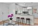 Open kitchen design with bar seating, white cabinetry, and hardwood floors at 5172 Sterrett St, North Charleston, SC 29405