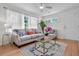 Bright living room with hardwood floors, area rug, neutral sofa and ample natural light at 5172 Sterrett St, North Charleston, SC 29405