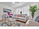 Living room featuring neutral sofa, area rug, hardwood floors, and bright natural light at 5172 Sterrett St, North Charleston, SC 29405