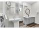 Modern bathroom featuring double sinks, decorative mirrors, and stylish fixtures at 5233 Maybank Hwy, Wadmalaw Island, SC 29487