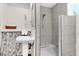 Bright bathroom showcasing a standalone shower, white pedestal sink, and shelving at 5233 Maybank Hwy, Wadmalaw Island, SC 29487
