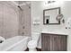 Bathroom with shower-tub, tiled wall, and vanity with decorative mirror at 5233 Maybank Hwy, Wadmalaw Island, SC 29487