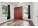 Bedroom featuring a Murphy bed and windows with natural views at 5233 Maybank Hwy, Wadmalaw Island, SC 29487