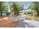 Exterior daytime view of property shows driveway, shed, and house at 5233 Maybank Hwy, Wadmalaw Island, SC 29487