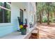 Cozy front porch with black rocking chairs and colorful flower pots, perfect for relaxing at 5233 Maybank Hwy, Wadmalaw Island, SC 29487