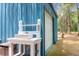 Exterior garage view of a blue metal shed with white door and outdoor sink at 5233 Maybank Hwy, Wadmalaw Island, SC 29487