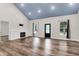Spacious living room features hardwood floors, natural light, and a cozy fireplace at 5233 Maybank Hwy, Wadmalaw Island, SC 29487