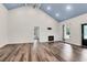 Open living area with hardwood floors, fireplace, and large windows at 5233 Maybank Hwy, Wadmalaw Island, SC 29487