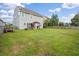 Expansive backyard with lush green grass, play set, and pergola-covered patio for Gathering fun at 535 Crossland Dr, Moncks Corner, SC 29461