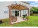 Inviting backyard patio with pergola, lounge chairs, and grill, perfect for outdoor entertaining at 535 Crossland Dr, Moncks Corner, SC 29461