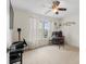 Cozy bedroom featuring a ceiling fan, carpeted floors, a dark desk, and a brightly lit window at 535 Crossland Dr, Moncks Corner, SC 29461