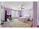 Charming bedroom with purple walls, plush carpet, and a bright window for ample natural light at 535 Crossland Dr, Moncks Corner, SC 29461
