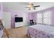 Spacious bedroom with purple walls and carpet, featuring a ceiling fan and a comfortable layout at 535 Crossland Dr, Moncks Corner, SC 29461