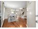 Open-concept dining room with hardwood floors, a modern table setting, and natural light, flowing into other living spaces at 535 Crossland Dr, Moncks Corner, SC 29461