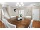 Inviting dining area with hardwood floors, a large wooden table, and white chairs at 535 Crossland Dr, Moncks Corner, SC 29461