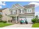 Charming two-story home with gray siding, attached garage, and a well-manicured front yard at 535 Crossland Dr, Moncks Corner, SC 29461