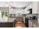 Modern kitchen with white cabinets, granite countertops, stainless steel appliances and access to the backyard at 535 Crossland Dr, Moncks Corner, SC 29461