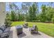 Backyard patio area featuring outdoor seating and a modern fire pit, ideal for gatherings and enjoying the green surroundings at 5725 Caviar Ct, Johns Island, SC 29455