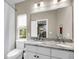 Bathroom featuring a double sink vanity with marble top, a large mirror, and a toilet at 5725 Caviar Ct, Johns Island, SC 29455