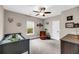 A cozy bedroom with a single bed, window and comfortable sitting chair, lit by a ceiling fan at 5725 Caviar Ct, Johns Island, SC 29455
