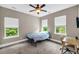 A cozy bedroom with three windows, a ceiling fan, and a desk, offers bright natural light at 5725 Caviar Ct, Johns Island, SC 29455