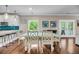 Dining room featuring a white table with chairs, view to the backyard, and stainless appliances at 5725 Caviar Ct, Johns Island, SC 29455