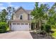 Inviting two-story home boasts a well-manicured lawn, two-car garage and a covered porch at 5725 Caviar Ct, Johns Island, SC 29455