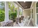 Covered porch with brick pillars offering cozy seating with elegant ceiling and manicured greenery at 5725 Caviar Ct, Johns Island, SC 29455