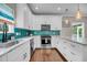 Beautifully updated kitchen with white cabinetry, marble countertops, and stainless steel appliances at 5725 Caviar Ct, Johns Island, SC 29455