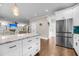 View of kitchen island with an open floorplan showcasing living area with custom built-ins and stainless refrigerator at 5725 Caviar Ct, Johns Island, SC 29455