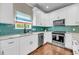 Lovely kitchen showcasing white cabinetry, marble countertops, stainless appliances, and green backsplash at 5725 Caviar Ct, Johns Island, SC 29455