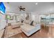 Bright, open living room featuring a large sectional couch, ceiling fan, and view into the updated kitchen at 5725 Caviar Ct, Johns Island, SC 29455