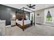 Spacious main bedroom with a dark wood canopy bed frame, accent wall, and bedside tables at 5725 Caviar Ct, Johns Island, SC 29455