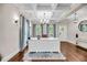 A bright office with wood floors, coffered ceiling, and blue curtains provides an elegant workspace at 5725 Caviar Ct, Johns Island, SC 29455