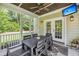 Inviting screened porch features a dining table, ceiling fan, and TV, perfect for outdoor relaxation and entertaining at 5725 Caviar Ct, Johns Island, SC 29455