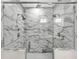 Luxurious walk-in shower featuring dual shower heads, marble-look tile, and mosaic tile floor at 5725 Caviar Ct, Johns Island, SC 29455