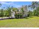 Side view of a two-story home highlighting the lush greenery and well-maintained lawn at 5725 Caviar Ct, Johns Island, SC 29455