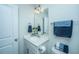 Well-lit half bathroom with a modern vanity, a mirror, and stylish accessories, offering a neat design at 618 Ravensridge Ln, Moncks Corner, SC 29461
