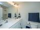 Bright bathroom featuring double sinks, a wide mirror, and a glass-enclosed shower with modern fixtures at 618 Ravensridge Ln, Moncks Corner, SC 29461
