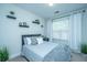 Cozy bedroom with a bed, decorative shelves, and natural light through the window at 618 Ravensridge Ln, Moncks Corner, SC 29461