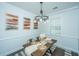 Cozy dining room features modern lighting, stylish decor, and a rustic wooden table for gatherings at 618 Ravensridge Ln, Moncks Corner, SC 29461