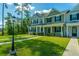 Beautiful townhomes with manicured lawns, sidewalks, and black trim evoke feelings of home at 618 Ravensridge Ln, Moncks Corner, SC 29461