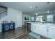 Bright kitchen featuring white cabinets, stainless steel appliances, and a blue accent cabinet with wine storage at 618 Ravensridge Ln, Moncks Corner, SC 29461