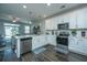 Open-concept kitchen featuring stainless steel appliances, white cabinets, and stylish island with seating and views at 618 Ravensridge Ln, Moncks Corner, SC 29461
