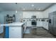 Open kitchen boasts stainless appliances, white cabinetry, and a spacious island perfect for meal prep and entertaining at 618 Ravensridge Ln, Moncks Corner, SC 29461