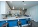 Inviting kitchen with white cabinets, marble countertops, pendant lighting, and stylish blue island with seating at 618 Ravensridge Ln, Moncks Corner, SC 29461