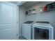Bright laundry room featuring a new washer and dryer and ample shelving space for storage at 618 Ravensridge Ln, Moncks Corner, SC 29461