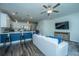 Open-concept living space connecting the kitchen with island seating, living area with TV, creating a seamless flow at 618 Ravensridge Ln, Moncks Corner, SC 29461