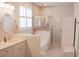Modern bathroom with a glass-enclosed shower, soaking tub, and white vanity at 683 Yellow Leaf Ln, Summerville, SC 29486