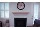 Cozy fireplace with a wooden mantel, white shutters, and a view to the backyard at 683 Yellow Leaf Ln, Summerville, SC 29486